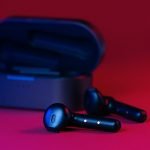 black and gray bluetooth earbuds