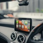 black iphone 4 on car dashboard